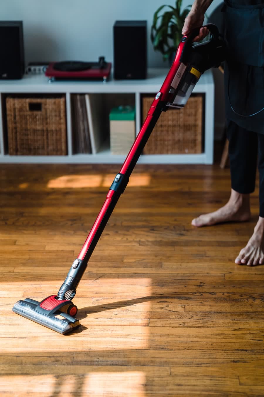 Vacuuming a hardwood floor before mopping